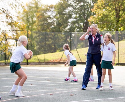 Netball coach and pupils